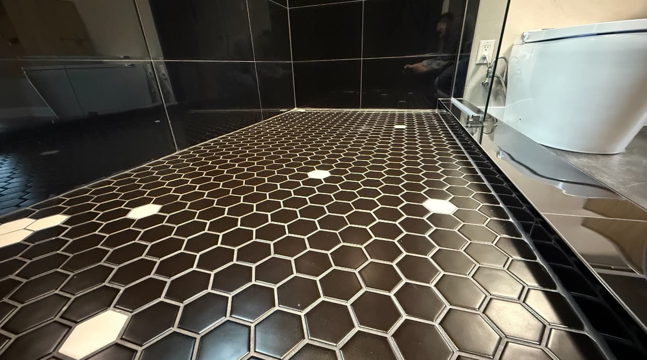 Black hexagon tile bathroom floor detail