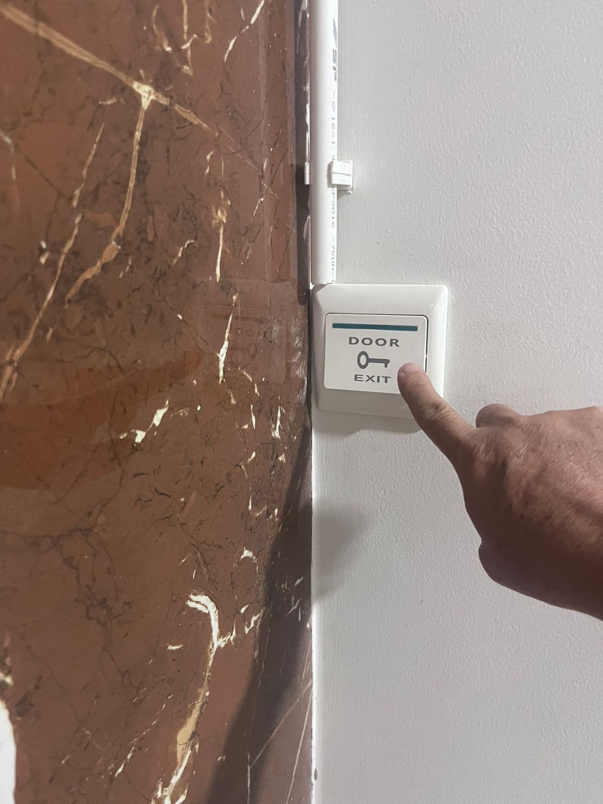 Door access control installation with marble tile wall