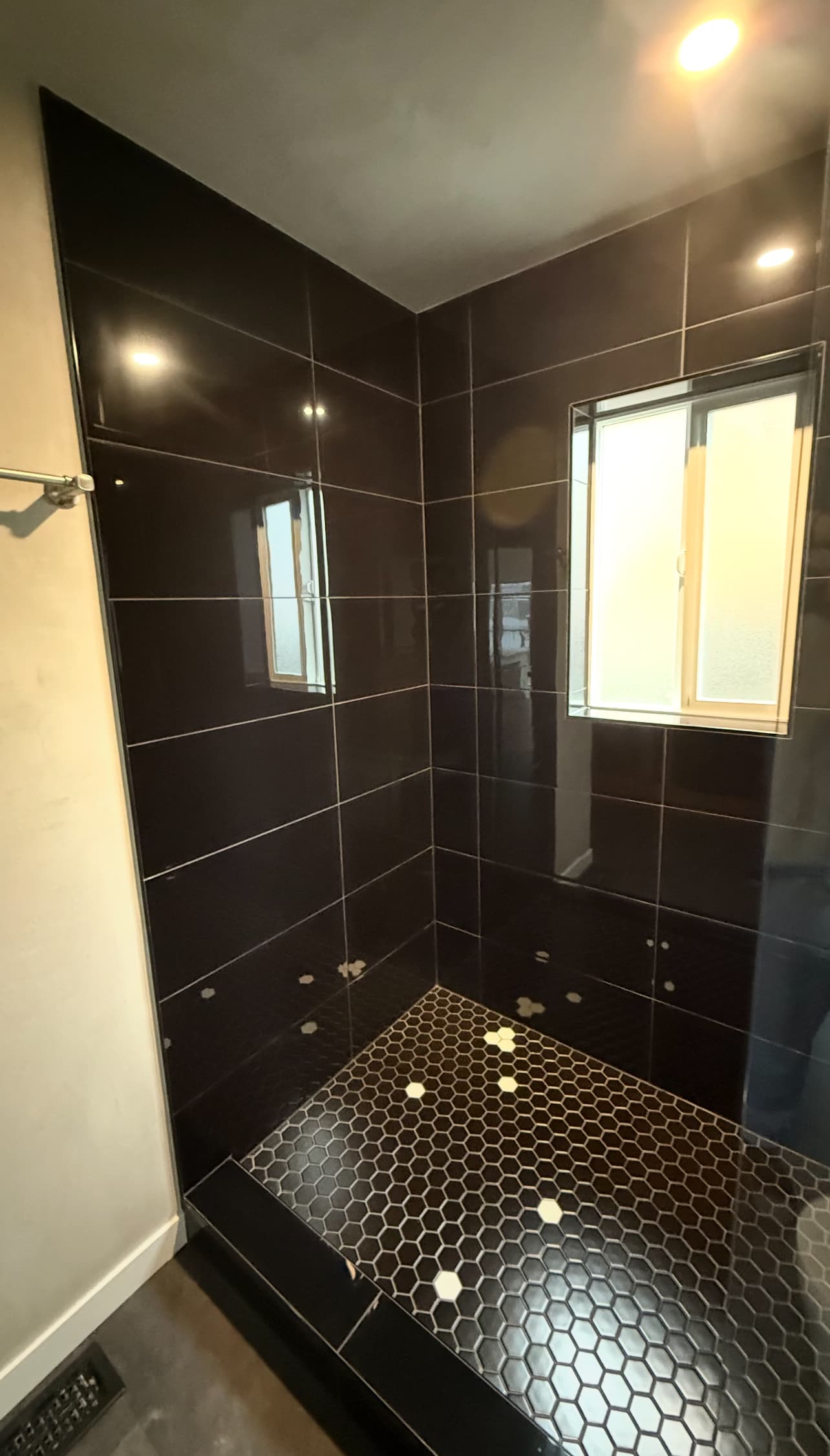 Luxury dark tile walk-in shower remodel