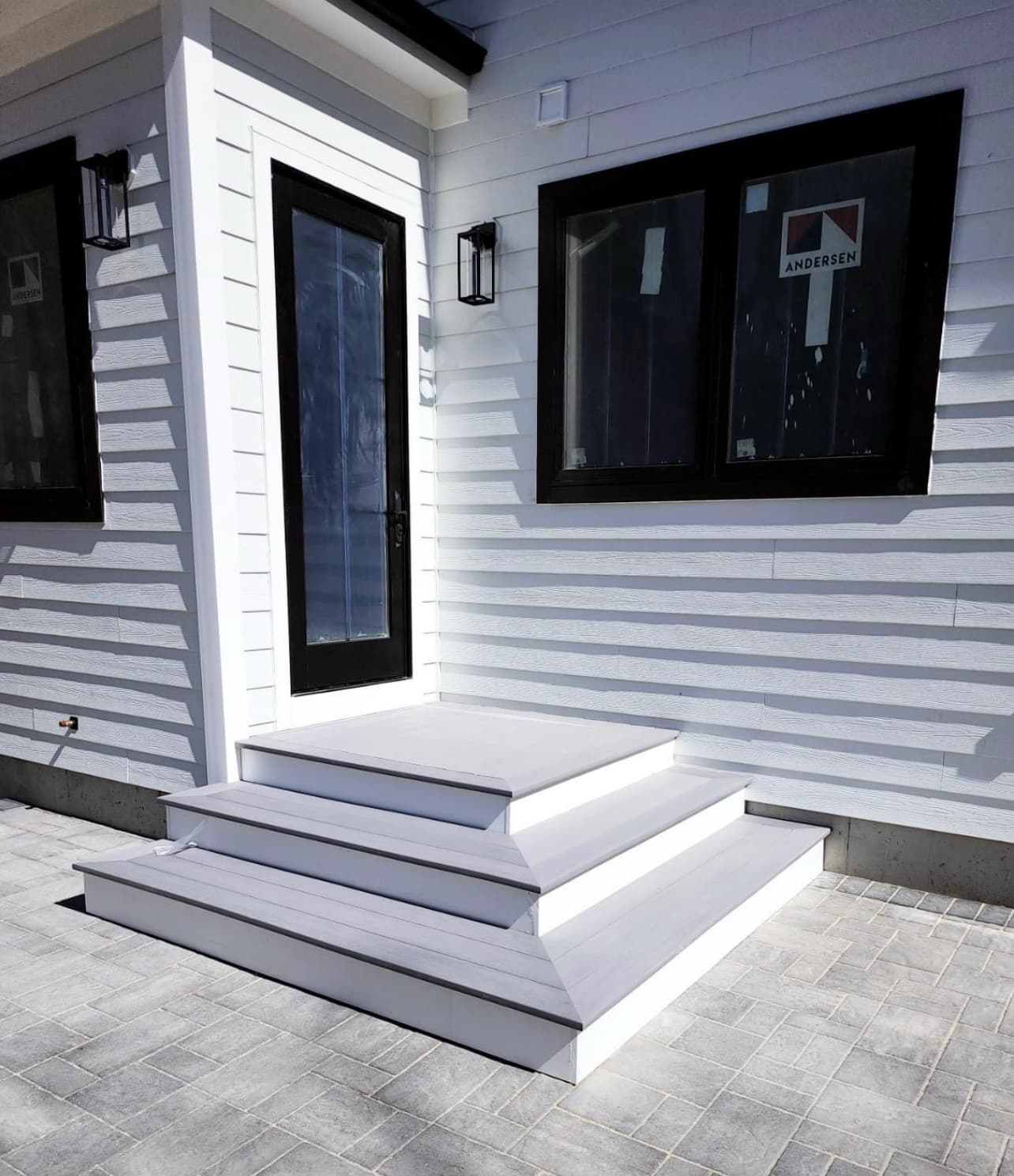 New exterior entry with white steps and black door